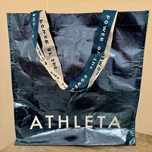 Athleta. This reusable Athleta bag is blue with a metallic finish. It's a stylis